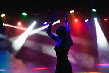 dancing silhouette of girl in a nightclub
