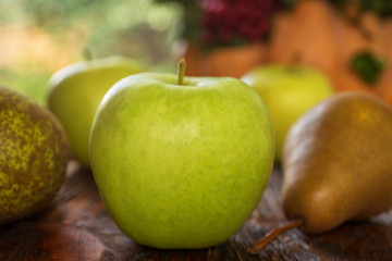 Apples of a pear, Pumpkin, viburnum, cones, nuts, acorns, chestnuts on a wooden background. Autumn composition by own hands