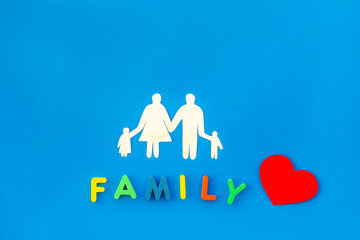 family word and figure for adopt child concept on blue background top view