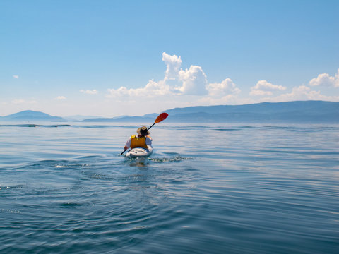 Rear view of man kayaking on Flathead Lake
