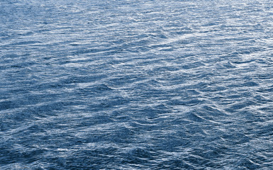Waves on the water during the wind. The texture of the water surface with waves_