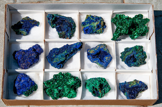 Close up of azurite and malachite mineral specimens in a box