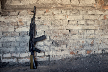 old submachine gun kalashnikov AK-47 against the wall