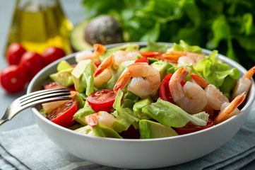 Salad with shrimps, avocado and cherry tomatoes.