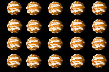 Vintage style ceramic cups, coffee brewing pot and sweet dessert – profitrole or eclair cakes with sugar powder on dark black background