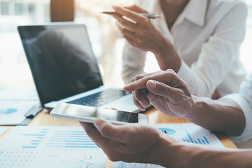 Asian advertising designer creative start-up team discussing ideas in office.