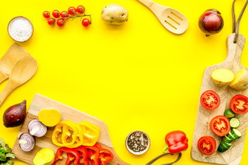 Fresh organic vegetables for healthy food cooking on yellow background top view mock up