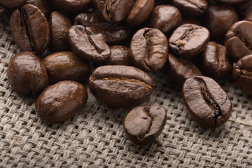 Freshly Roasted Coffee Beans close-up on burlap for background or decor.