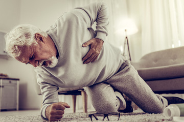 Aging grandfather falling down because of shooting pain in heart
