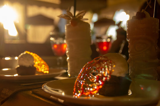 Caramel dessert with milkshake in twilight. Backlight at sunset.