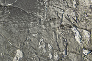 Peeling black paint on a concrete wall. Abstract background. 