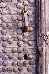 Fototapeta na wymiar Old wooden door with metal rivets in Plovdiv, Bulgaria, detail