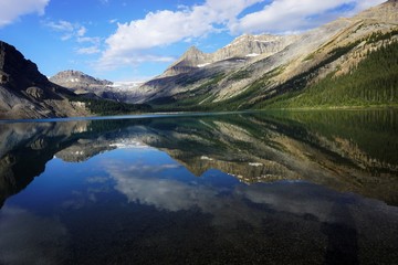 Fototapeta na wymiar Mountains reflection in Bow Lake in National park Banff in Canada