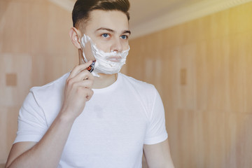 morning hygiene, man shaves with foam