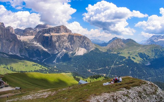 Italy beauty, Dolomites, tourist family on Col Rodella with view to massif Sella