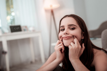 Upset teenager girl trying to make a smile