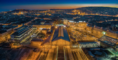 Budapest, Hungary - Aerial panoramic skyline view of Budapest at dusk with illuminated Western Railway Station, Parliament, St. Stephen's Basilica, Buda Castle Royal Palace and Fisherman's Bastion