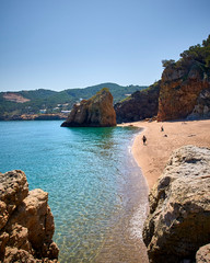 Beautiful nudist beach of Platja de Pals, Costa Brava, Girona - Spain. Rocky rough coastline. Mountain vegetation beautiful summer day. Common tourism destination for French, Dutch, German, English.