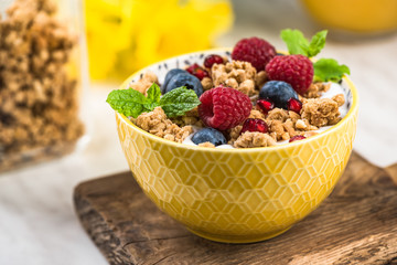 Breakfast or brunch, granola with milk and berry fruits