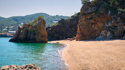 Beautiful nudist beach of Platja de Pals, Costa Brava, Girona - Spain. Rocky rough coastline. Mountain vegetation beautiful summer day. Common tourism destination for French, Dutch, German, English.