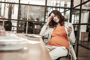 Fototapeta premium Disturbed long-haired woman being in hard emotional and physical condition