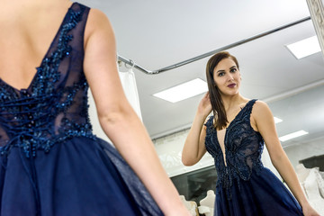 Beautiful woman in elegant evening dress posing for camera