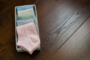 Box of sport socks on wooden background