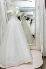 Beautiful wedding dress on a mannequin in salon