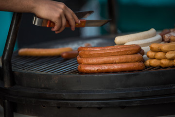 Hot Dogs on Grill Cooking