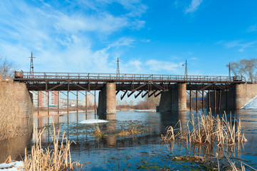 Kommunar dam, a pedestrian bridge over the Miass river
