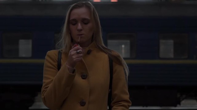 Real Time Girl Lighting Cigarette At Railway Station