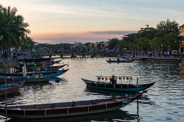 Traditional boats in front of ancient architecture in Hoi An, Vietnam. Hoi An is the World's Cultural heritage site, famous for mixed cultures & architecture.