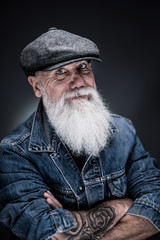studio portrait of a senior hipster with a long white beard