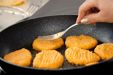 fried carrot fritters in a pan