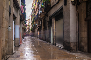 Fototapeta na wymiar Long-exposure view of the Corders street in the Gothic Quarter in overcast day, Barcelona, Spain