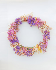 first of May handmade colorful flowers wreath, soft and airy blur on white background