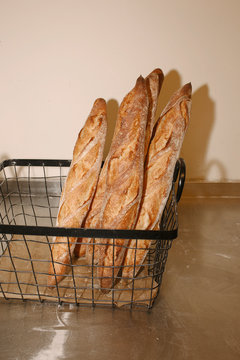 Freshly Baked Artisan Baguettes in Wire Basket