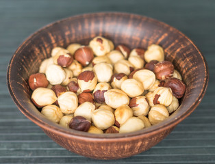 Healthy food  for background image close up hazelnuts.  Nuts texture on top view on the cup plate