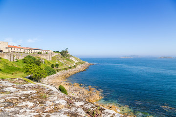 Obraz premium Baiona, Spain. Scenic view of the fortress of Monterreal on the ocean. List of the most picturesque historical buildings of UNESCO