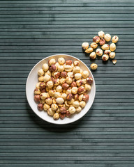 Healthy food  for background image close up hazelnuts.  Nuts texture on top view on the cup plate
