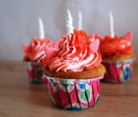 Delicious colorful cupcakes -unicorns with cheese cream for children's birthday.