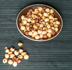 Healthy food  for background image close up hazelnuts.  Nuts texture on top view on the cup plate
