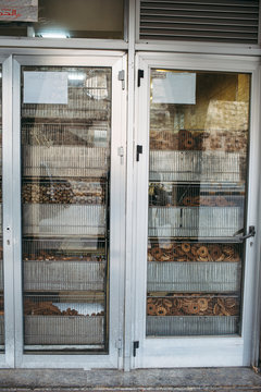 Traditional Bakery Shop Front with Assorted Baked Goods Displayed Behind Glass Doors