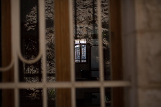 Window Light Through Blurred Bars in an Old Stone Interior