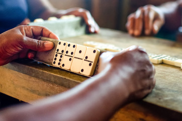 Women are playing domino which is traditional in Cuba