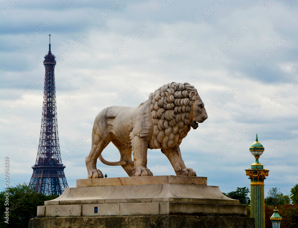 Wall mural Statue of lion in Place de la Concorde against the backdrop of the Eiffel Tower, Paris, France