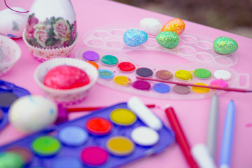 Preparation for Easter. Coloring eggs with watercolors and markers. Child play, Easter concept