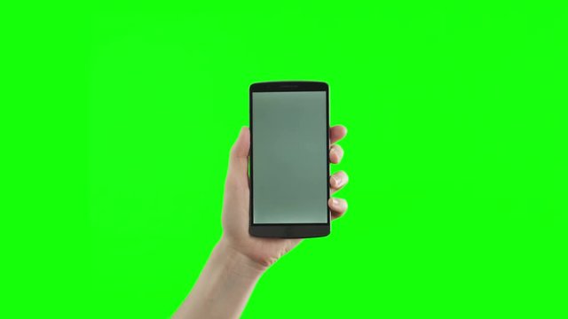 Female hand holding the new smartphone on green screen