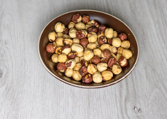 Healthy food  for background image close up hazelnuts.  Nuts texture on top view on the cup plate