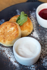 Cottage cheese pancakes with blueberry and mint for Breakfast or lunch. Jam and sour cream.